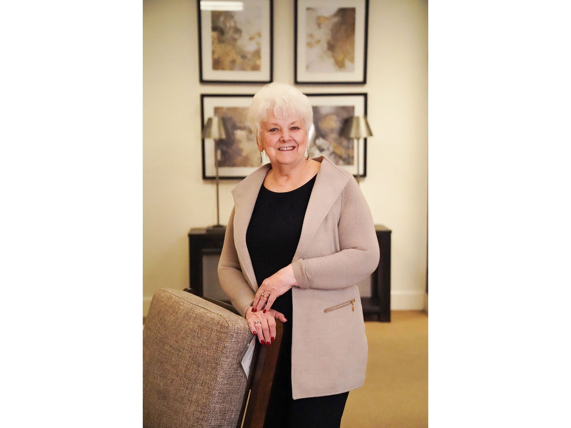 A woman leaning on a chair