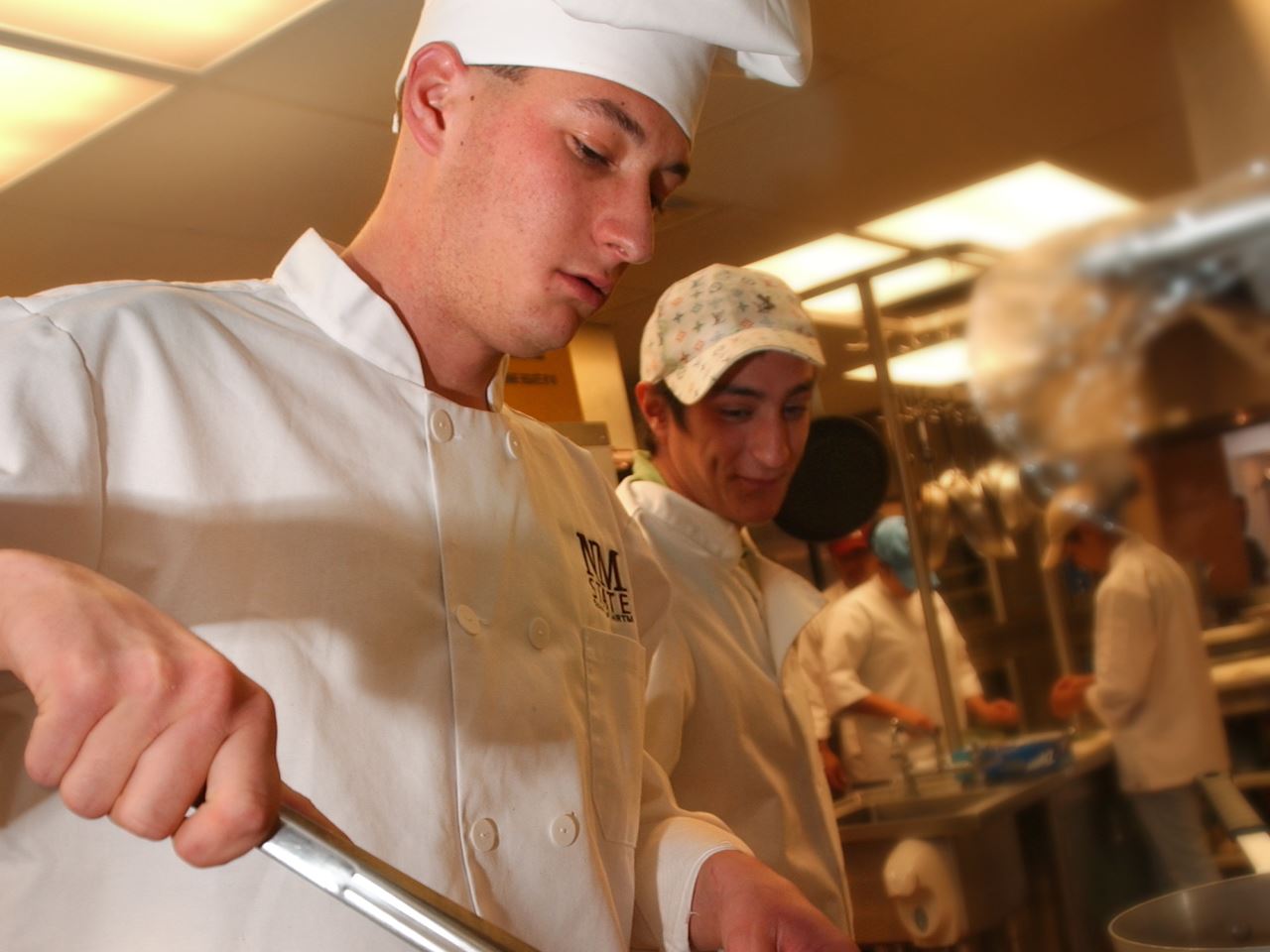 Photo of HRTM students cooking vegetables during food preparation class