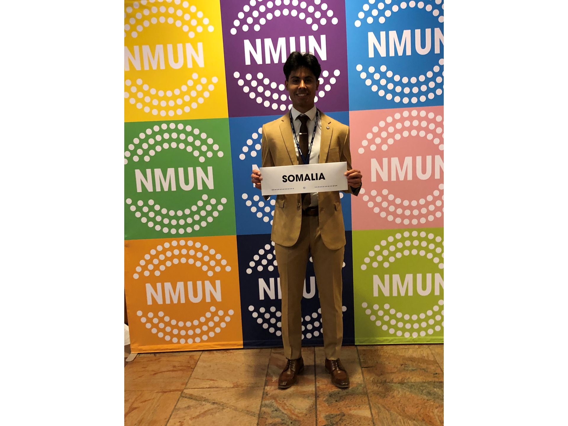 Male student holding a sign