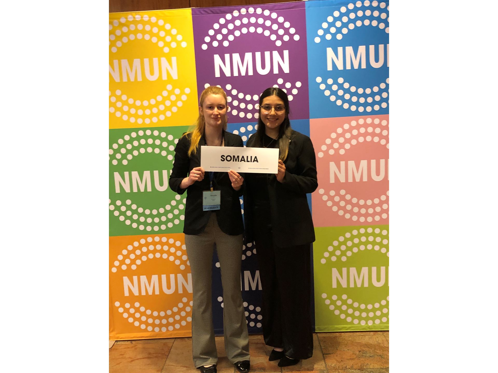 Two female students holding a sign