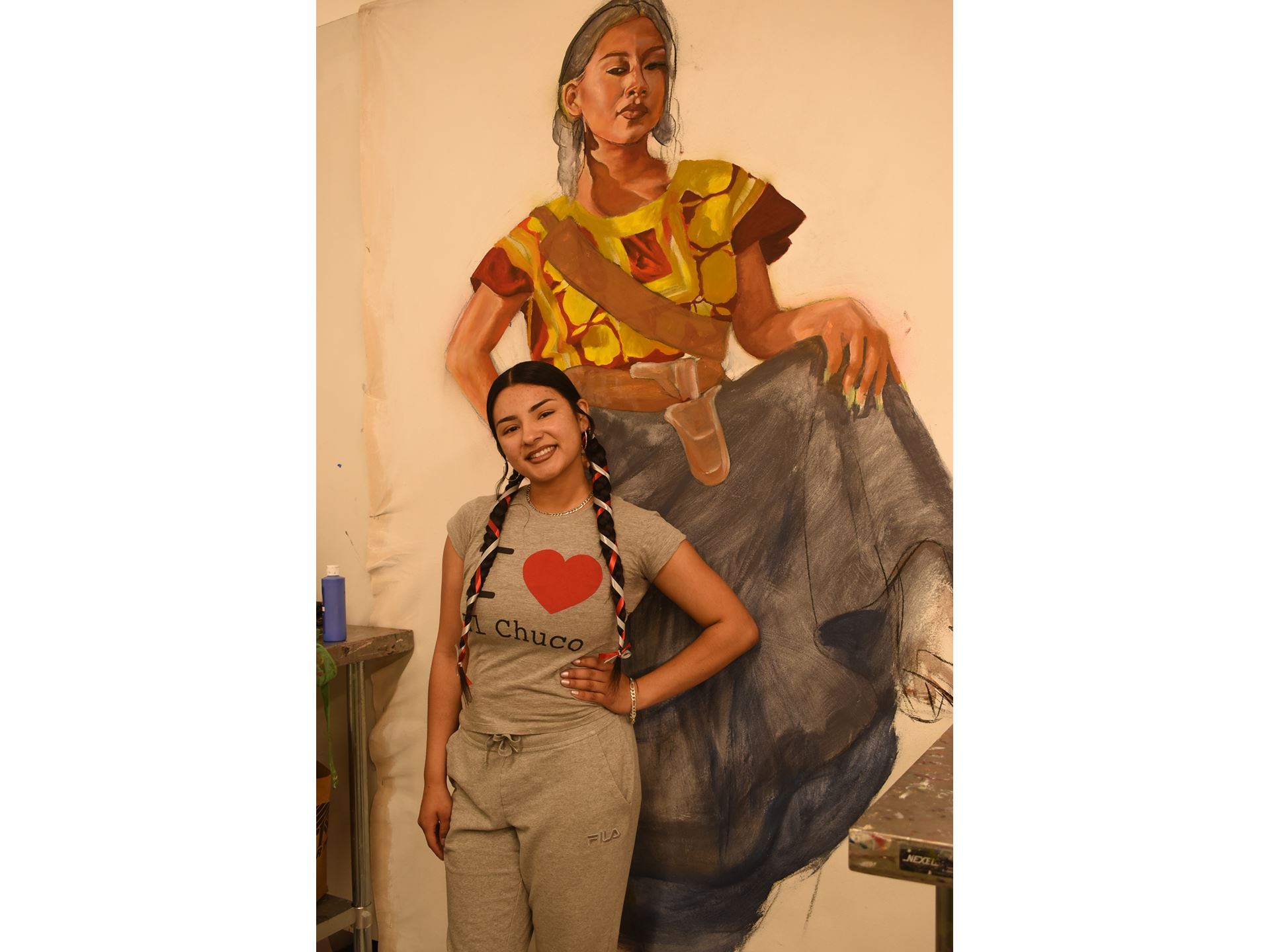 A girl standing in front of a painting