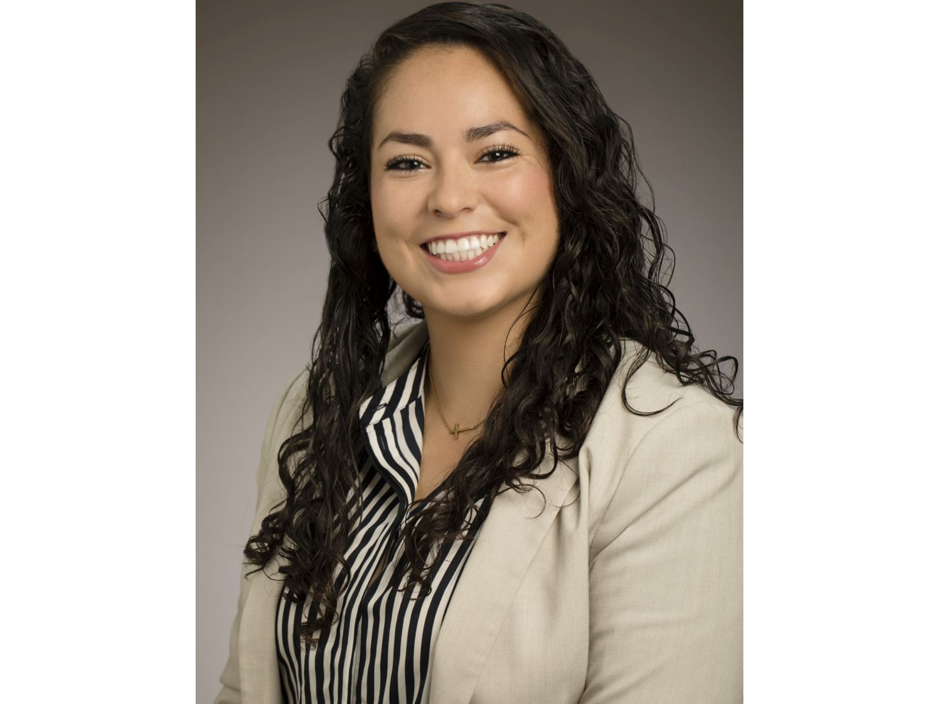 Portrait of smiling woman with brown curly hair