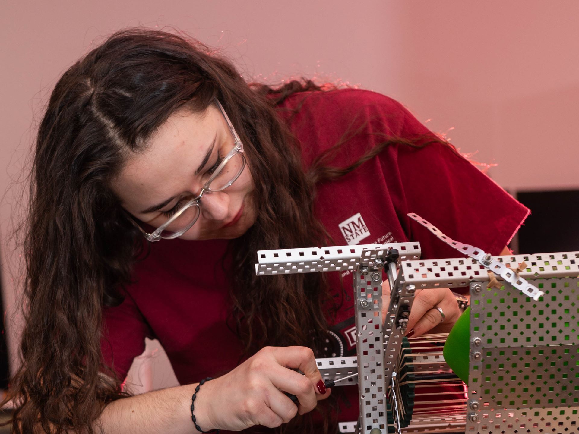 Maria Adeliz Ordoñez, former New Mexico State University Robotics club president, works on a robot in Jett Hall. (NMSU photo by Josh Bachman)