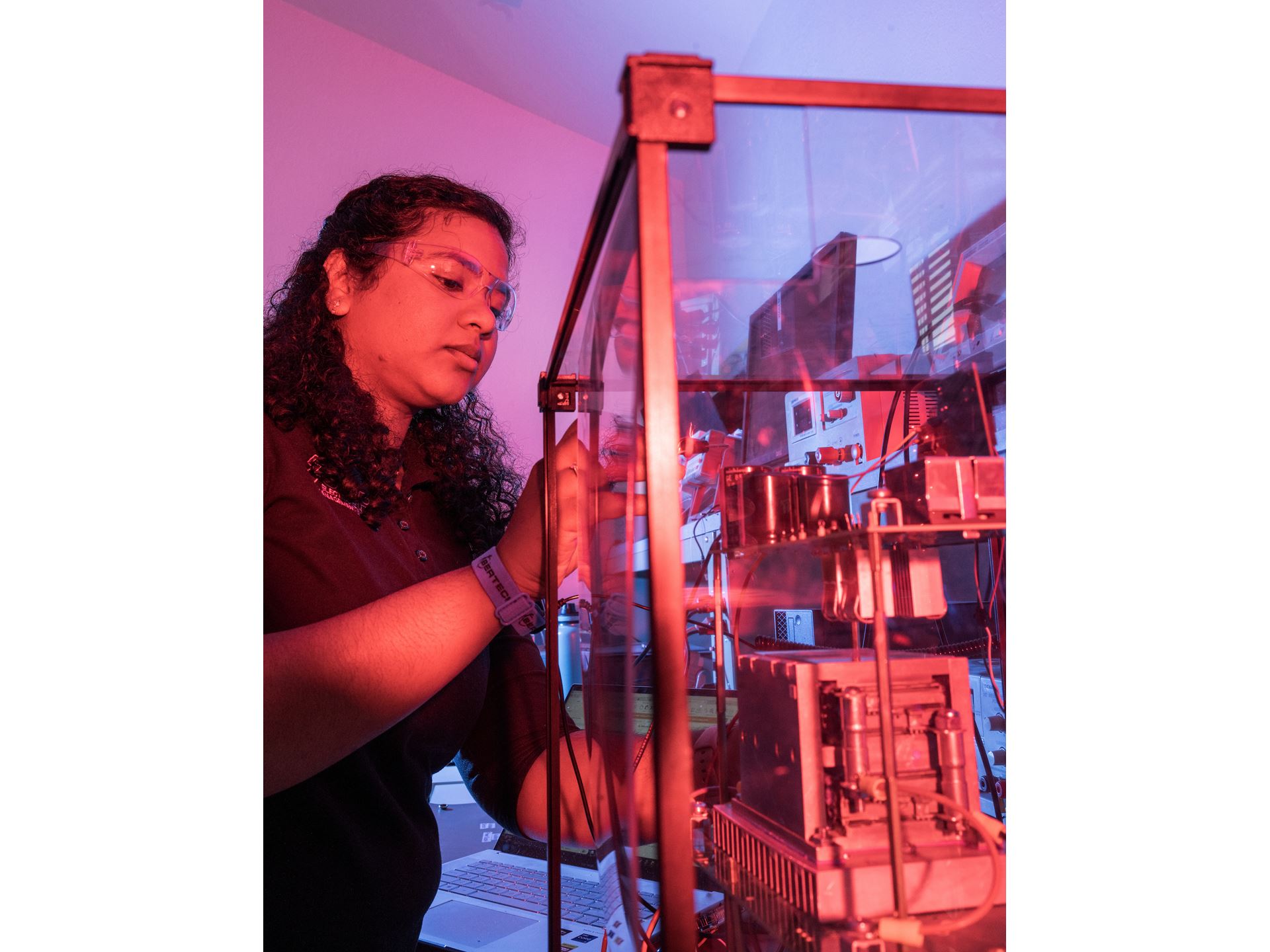 IMAGE DESCRIPTION Woman standing next to electrical equipment