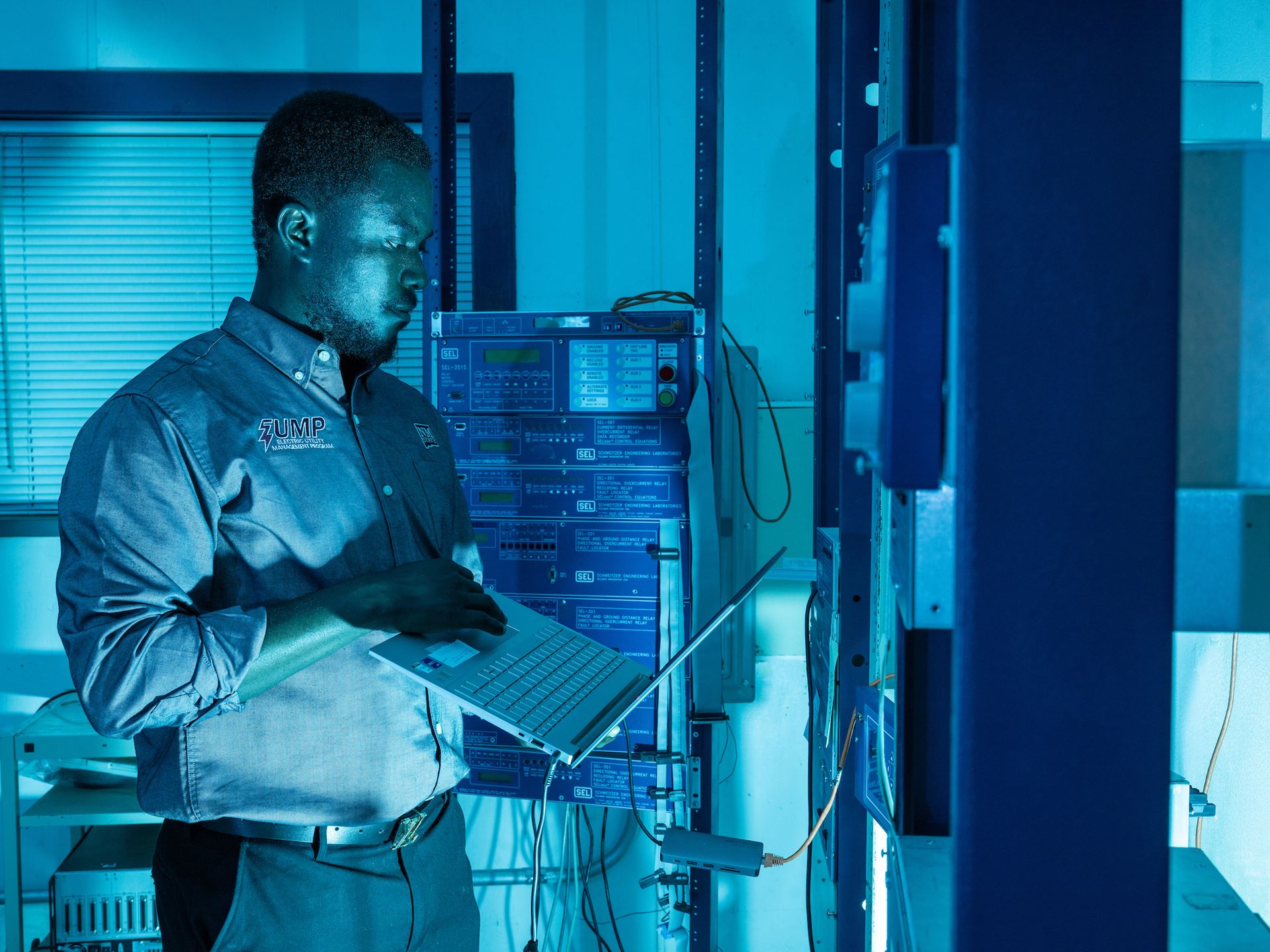 IMAGE DESCRIPTION Man standing next to electrical equipment