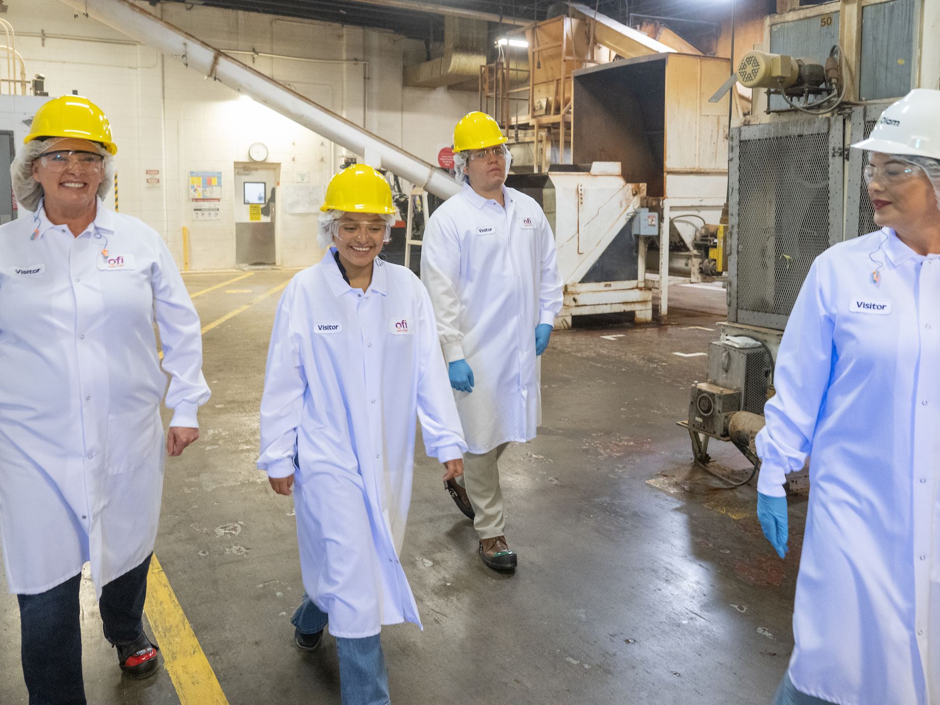 Photo of students and staff touring Olam Food Ingredients production facility