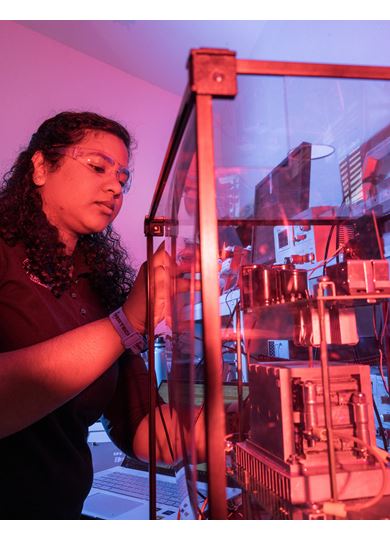 IMAGE DESCRIPTION Woman standing next to electrical equipment