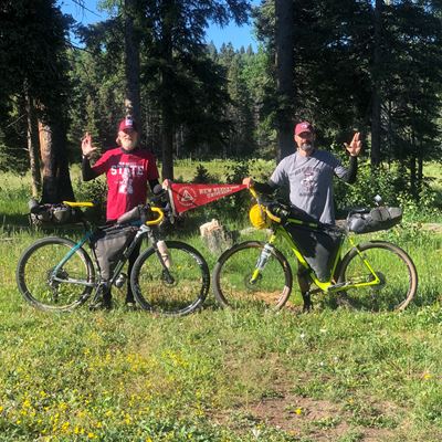 Raymond Johnson (left) and Shane Cunico show off their New Mexico State University Aggie pride as they bike through..