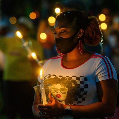People hold candles during New Mexico State University’s Juneteenth celebration last year. This year’s event will take p