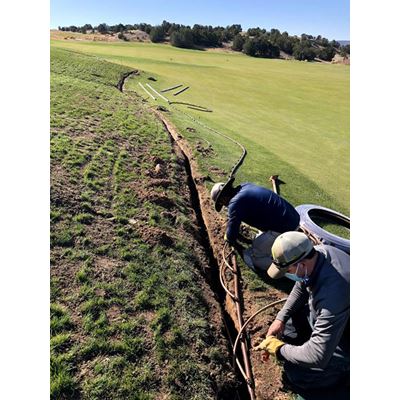 Employees of The Club at Las Campanas golf course in Santa Fe install subsurface drip irrigation along on the fairway ro