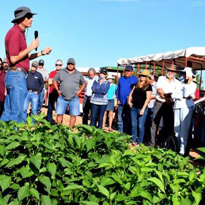 During a 2019 field day, Brian Schutte, New Mexico State University associate professor in weed science, talks to visito