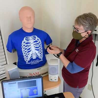 Alexa Doig, director of the School of Nursing at New Mexico State University, performs a physical assessment on...