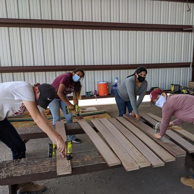 Aggies Without Limits students prepare the bridge deck for the Otero County Fair pedestrian bridge. (Photo courtesy AWL)