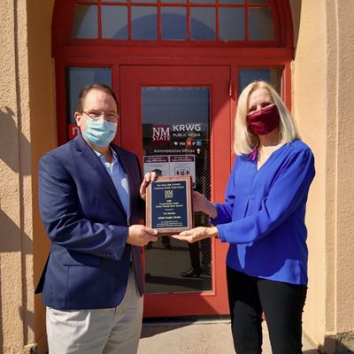 New Mexico State University associate professor Cindy Kratzke, right, presents a Public Health Heroes Award to Fred Mart