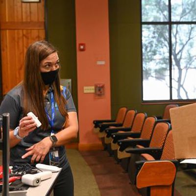 Jennifer Ross, left, of Electronic Caregiver, explains the equipment that Carol MacDonald, right