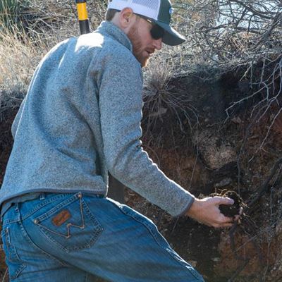 ACES_MAG_Soil_CoverJeremy Schallner, a Ph.D. student in the Department of Animal and Range Sciences, holds a handful of