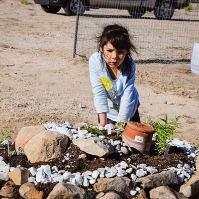 Sinnery Lynne Begay looks at a spiral garden at the Sheep Spring Senior Citizen Center demonstration garden