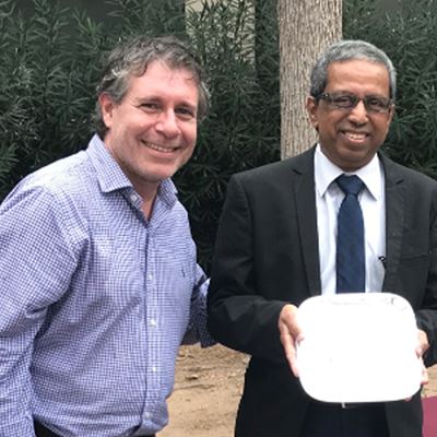 Enrico Pontelli, dean of the College of Arts and Sciences, presents Srini Kankanahalli, his award as a 2019 distinguishe