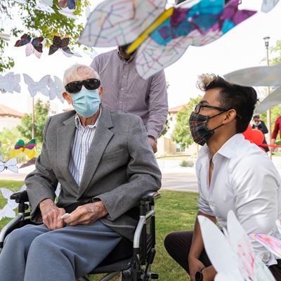 Artist Jesus Del Rio with J. Paul Taylor at the entrance to “Mariposas Campesinas” at the College Assistance Migrant Pro