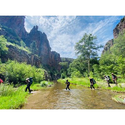 A group of students crossing a river