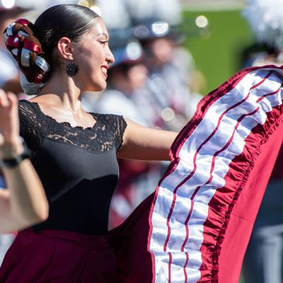 New Mexico State University Folklorico dancer at football game