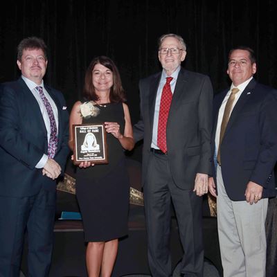 Photo of Angela Throneberry receiving College of Business Hall of Fame plaque