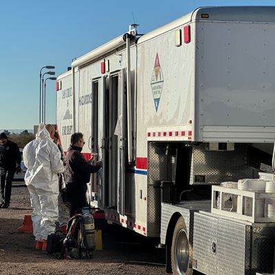 Four people standing next to an emergency vehicle