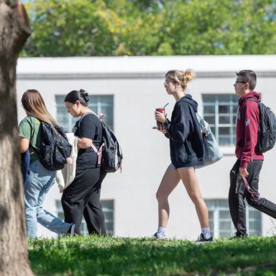 Group of students walking outdoors on campus