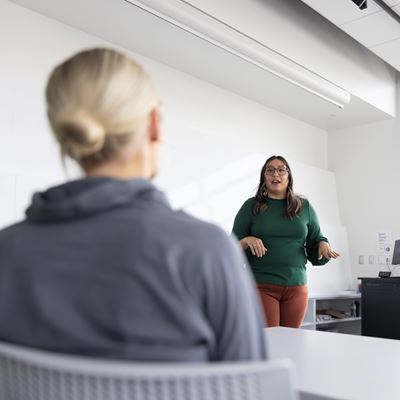 A woman presenting information to employees