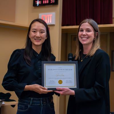 IMAGE DESCRIPTION Two women holding a plaque