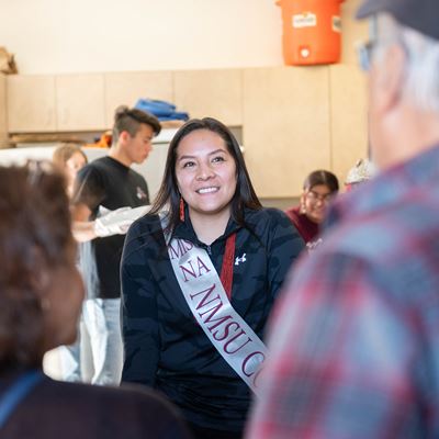 Woman speaking with two people