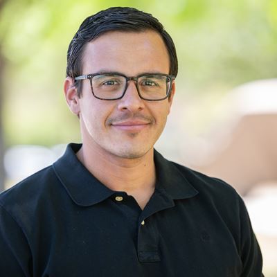 Head and shoulders of a man wearing glasses