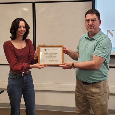 Photo of Olivia Belian and Joseph Holles with official chapter certificate