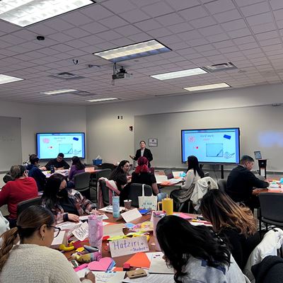 IMAGE DESCRIPTION A group of people seated in a classroom