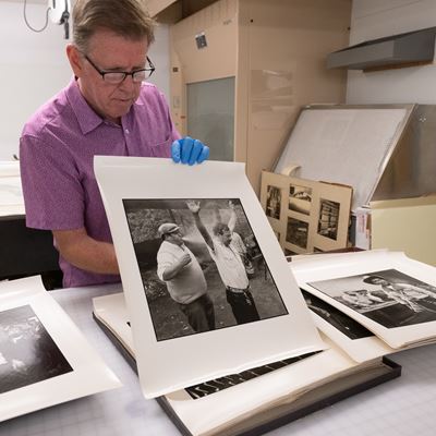 Photo of Dennis Daily department head of NMSU Archives sharing Sterling Trantham s photos in collections