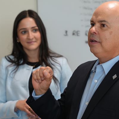 Photo of GM top executives speaking with College of Business supply chain program students
