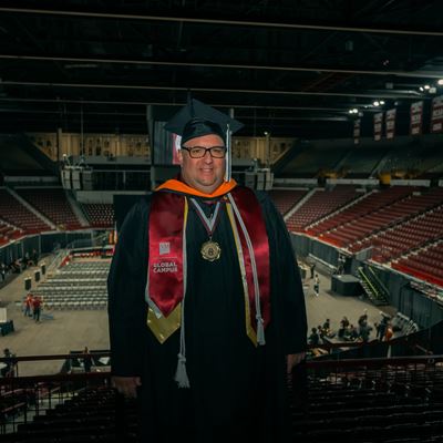 IMAGE DESCRIPTION Man wearing a commencement cap and gown