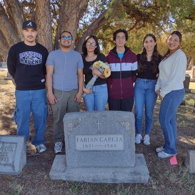 Photo of students at Fabian Garcia tombstone at cemetery