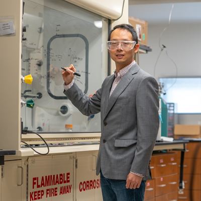 IMAGE DESCRIPTION Man writing on a clear board with a marker
