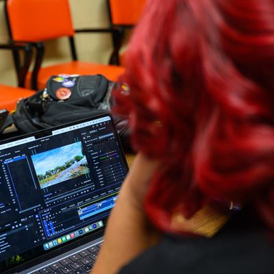 Woman with red hair looking at a laptop