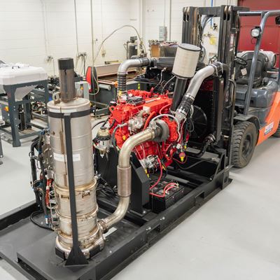 Description A large diesel engine with computer controls in a machine shop