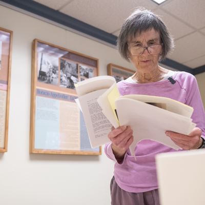 Photo of Lee Byrd looking through Bobby Byrd s collections at NMSU Archives and Special Collections