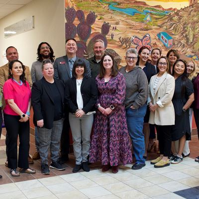 IMAGE DESCRIPTION A photo of a group of people standing in a lobby