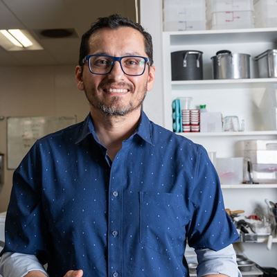 IMAGE DESCRIPTION Man in a laboratory holding a container of ice cream