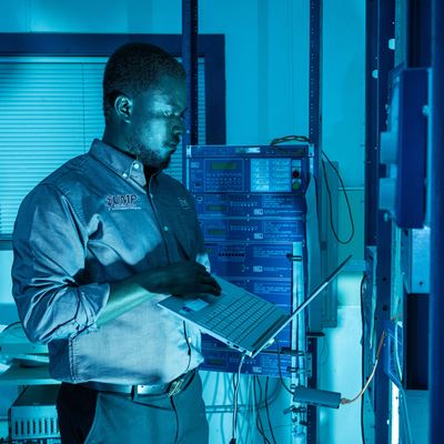 IMAGE DESCRIPTION Man standing next to electrical equipment