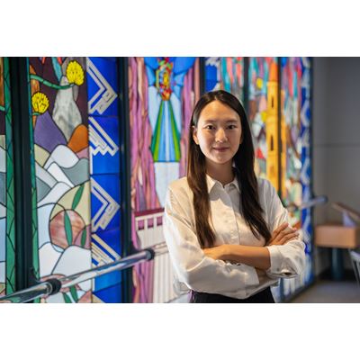 IMAGE DESCRIPTION A woman standing with her arms crossed in front of her