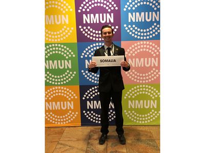 Male student holding a sign