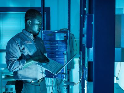 IMAGE DESCRIPTION Man standing next to electrical equipment