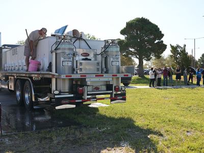 Photo of first fish stocking at Alumni Pond