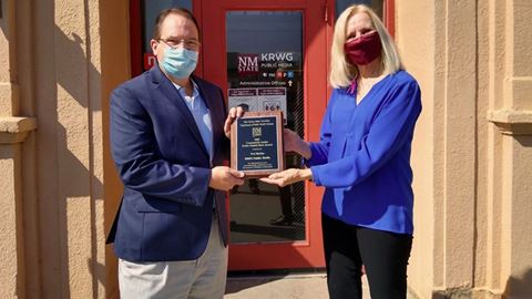 New Mexico State University associate professor Cindy Kratzke, right, presents a Public Health Heroes Award to Fred Mart